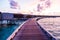 Blissful shot of bungalows and a jetty walk in beautiful Maldives at sunset