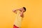 Blissful young man in trendy bright t-shirt laughing in studio. Indoor photo of emotional african g