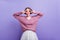 Blissful young woman fooling around while posing in trendy purple sweater. Graceful lady with dark-brown hair making