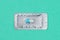 Blister or pack of one very important and expensive tablet or pill. Light purple background. Turquoise background