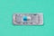 Blister or pack of one very important and expensive tablet or pill. Turquoise classic traditional medical background