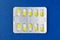 Blister or pack of ten medical tablets or pills. Dark blue background