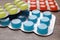 Blisters with colorful cough drops on wooden background, closeup