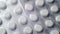 Blisters with white pills.moving background.close-up. top view