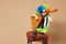 Blithesome children. Happy clown boy in large neon colored wig p