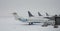 Blizzard on an international airport, airplanes waiting grounded in the snow