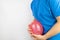 Bloating and flatulence concept. The man holds a red balloon near the abdomen, which symbolizes gas problems. Intestinal tract and