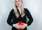 Bloating and flatulence concept. The woman holds a red balloon near the abdomen, which symbolizes bloating. Intestinal tract and d