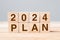 block 2024 PLAN text on table. Resolution, strategy, goal, motivation, reboot, business and New Year holiday concepts