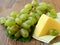 block cheese and fresh grapes