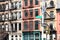 Block of colorful old apartment buildings on 6th Avenue in the Tribeca neighborhood of New York City