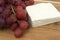 Block of feta cheese with fresh grapes