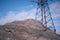 A block of ore on the background of a metal structure of a power line support. The concept of using natural resources