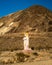 Block sculpture of a female in the middle of the desert