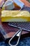 Block of smoked cheese grated on vintage metal grater