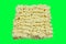 A block of uncooked Ramen Noodles Isolated on green screen