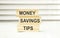 block with word \\\'money\\\' on top of a blocks with words \\\'money savings tips\\\'.