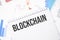 blockchain text on paper on the chart background with pen