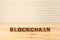 Blockchain word written on wood block. Block chain text on wooden table for your design