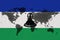 Blockchain world map on the background of the flag of lesotho and cracks. lesotho cryptocurrency concept