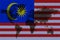 Blockchain world map on the background of the flag of Malaysia and cracks. Malaysia cryptocurrency concept