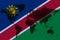 Blockchain world map on the background of the flag of Namibia and cracks. Namibia cryptocurrency concept