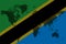 Blockchain world map on the background of the flag of tanzania and cracks. tanzania cryptocurrency concept