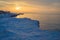 Blocks of ice on the seashore at sunset