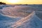 Blocks of ice on the seashore at sunset