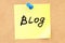 Blog! Text on a sticky note pinned to a corkboard. 3D rendering