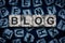 Blog, word on an alphabet on stone blocks, on dark blue background