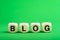 Blog. Word from letters on wooden cubes. On a green background