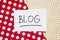 Blog - word on red and golden blackboard, internet blogging concept