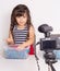 Blogger kid posing in front of camera for recording homemade video to vlog. Children make vlog for social media channel. Blogging,