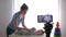 Blogger profession, modern mother vlogger changes clothes of kid boy while recording training video on mobile phone for
