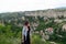 Blogger woman with red hat on a touristic sightseeing in the top of the hill at the balkan with a backpack.