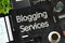 Blogging Services - Text on Black Chalkboard. 3D Rendering.