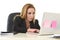 Blond attractive 40s woman in business suit working at laptop co