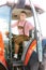 Blond bavarian man sitting on tractor