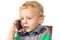 Blond boy careful talking on a cell phone