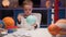 Blond boy paint planet solar system Uranus with colorful paint sitting home table in evening, planet solar system