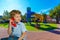 Blond boy speaks on a red telephone