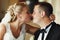 Blond bride touches groom\'s nose tenderly holding his head