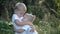 The blond brother hugs his sister. Children play outdoors in the countryside.Summer entertainment for children. Healthy