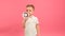 Blond caucasian 5-year-old child in white T-shirt shouts into megaphone and agitates for purchase of goods at sale with