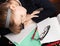 Blond Caucasian schoolgirl sleeps on desk