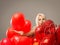 Blond cheerful woman with red balloons heart