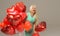 Blond cheerful woman with red balloons heart