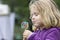 Blond child licking a lollipop