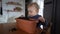 Blond child plays with soil in a flower pot. Helps to transplant indoor plants or seedlings, small gardener
